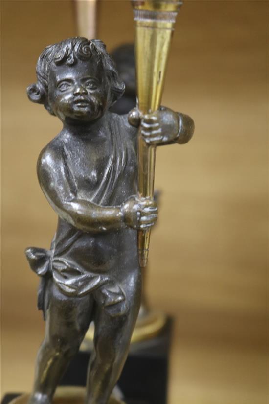 A pair of French bronze and gilt metal candlesticks